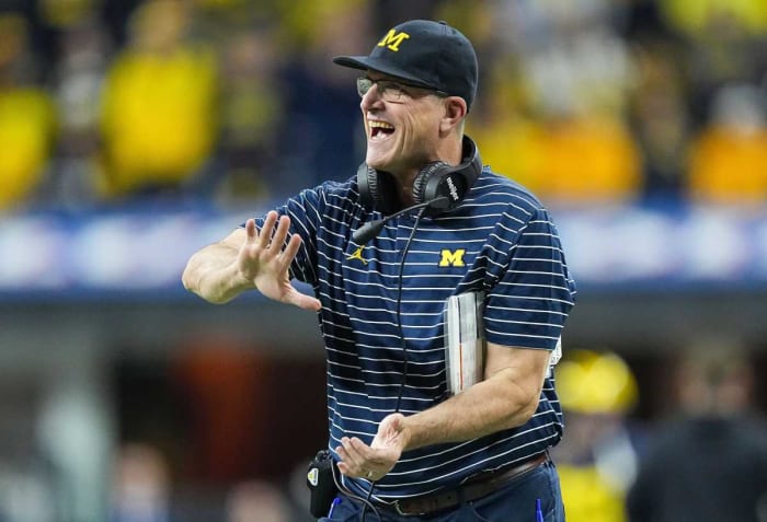 Michigan Wolverines head coach Jim Harbaugh high fives players as they leave the field during the Big Ten football championship on Saturday, Dec. 3, 2022 at Lucas Oil Stadium in Indianapolis. Michigan Wolverines defeated the Purdue Boilermakers, 43-22. Ncaa Football Big Ten Championship Football Game Purdue Boilermakers At Michigan Wolverines